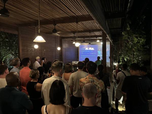 An audience facing a screen during a talk